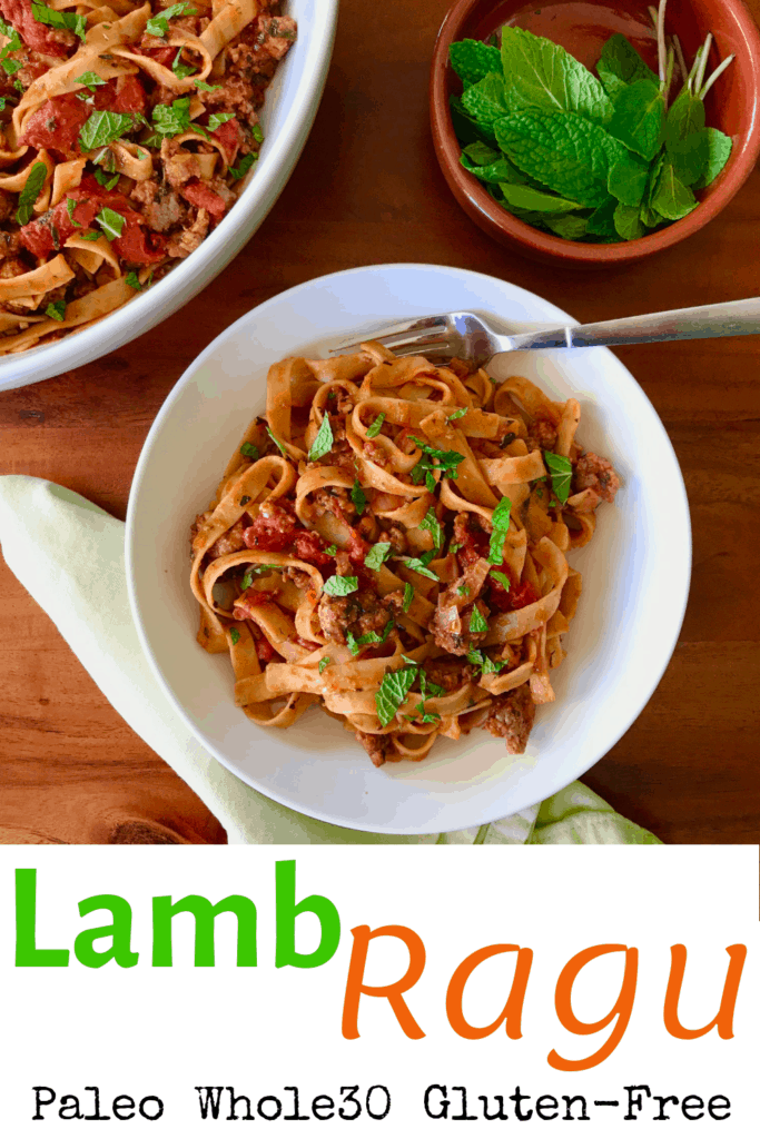Lamb Ragu in a white bowl on a wooden table next to a white bowl with more lamb rage and a little bowl of fresh mint