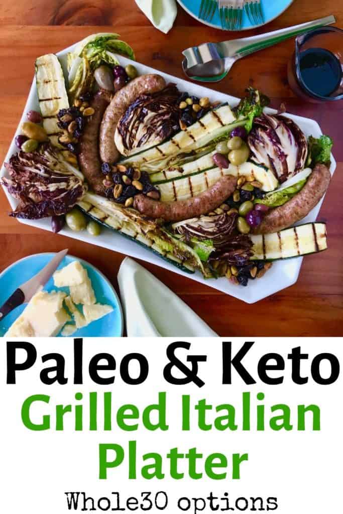 Grilled Italian Platter on a white dish surrounded by blue plates with cheese, forks and food all on a wooden table