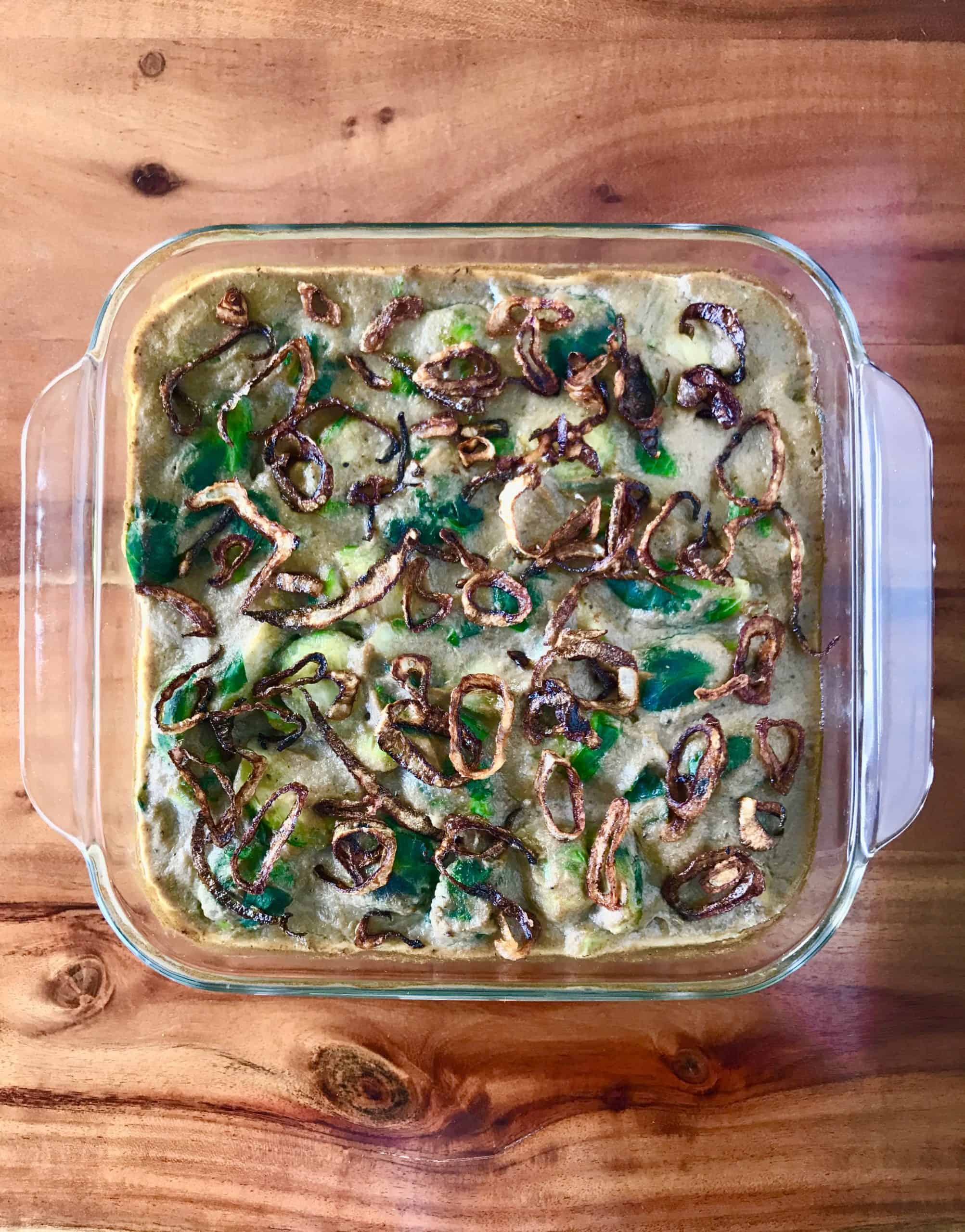 Brussels Sprouts Casserole in a glass dish on a wooden table