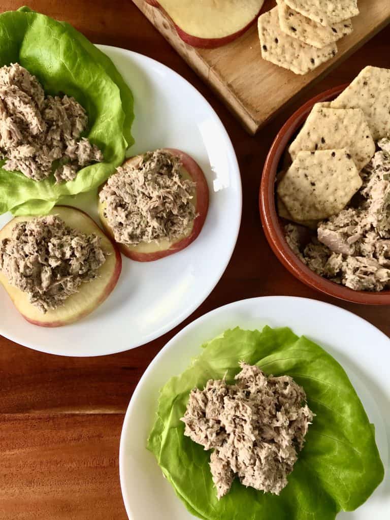Whole30 tuna salad with sardines on lettuce wraps and apple slices on white plates and in a bowl with crackers