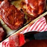 oven baked pork chops with bbq sauce on a baking sheet
