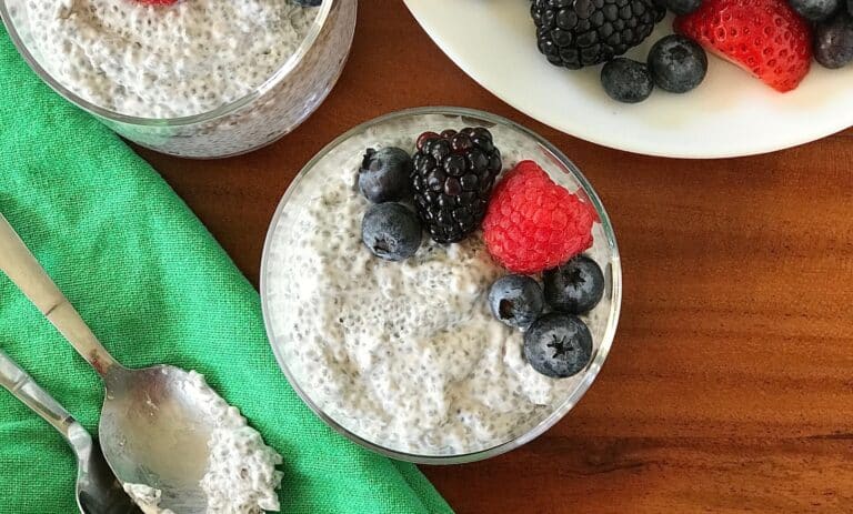 vanilla chia pudding in a glass topped with berries