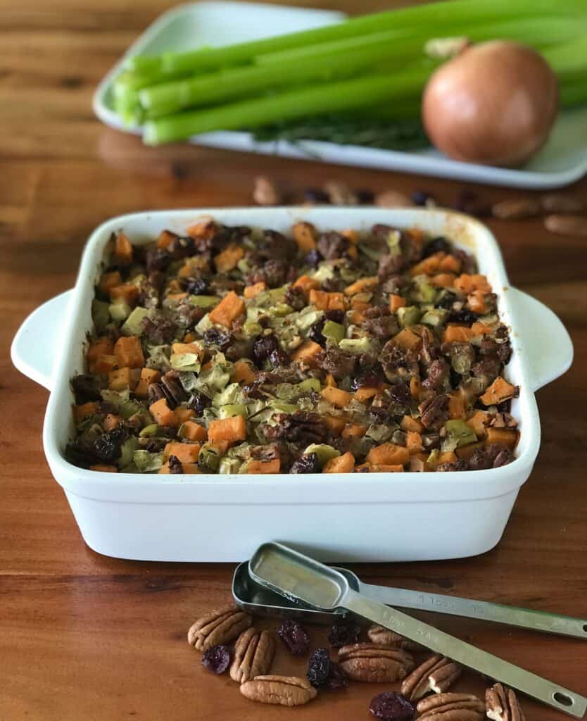Paleo Thanksgiving stuffing with sausage, sweet potato and apple in a white baking dish