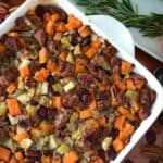 gluten-free stuffing with sausage, sweet potato and apple in a white baking dish