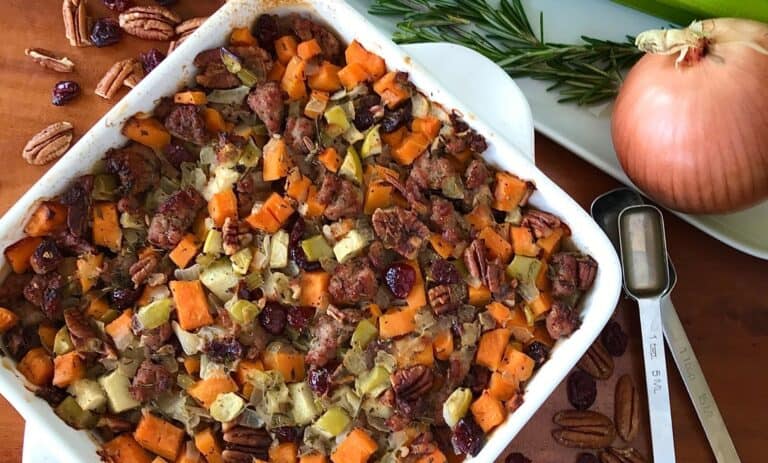gluten-free stuffing with sausage, sweet potato and apple in a white baking dish