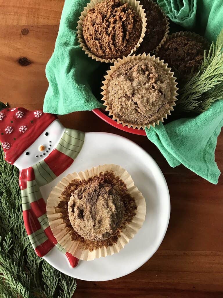 flourless ginger molasses muffins on a white snowman plate and in a red tin with a green towel