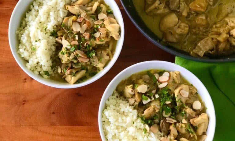 chicken curry with coconut milk in white bowls with cauliflower rice
