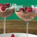 an easy no bake ricotta dessert recipe with chocolate piled into coupe glasses and topped with raspberries