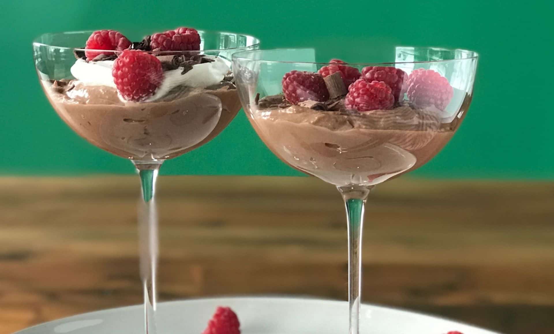 an easy no bake ricotta dessert recipe with chocolate piled into coupe glasses and topped with raspberries