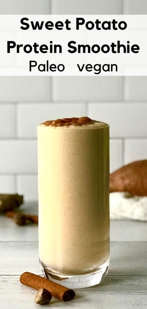 A Sweet Potato Protein Smoothie in a tall glass next to a cinnamon stick and half a nutmeg