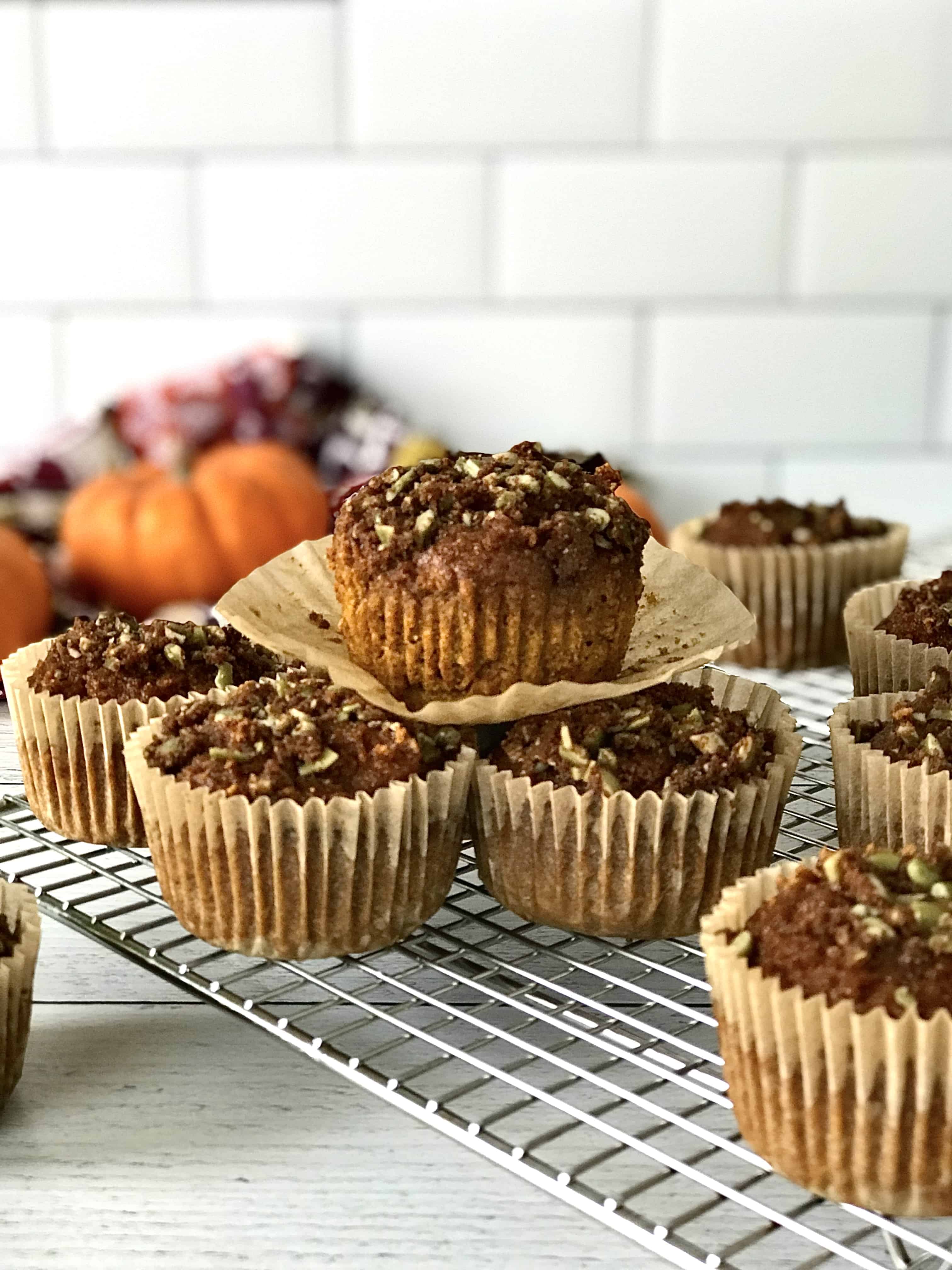 gluten-free pumpkin muffins in their brown muffin cups on a wire cooling rack