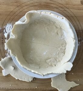 paleo pie dough in a pie dish before it's been made to look pretty