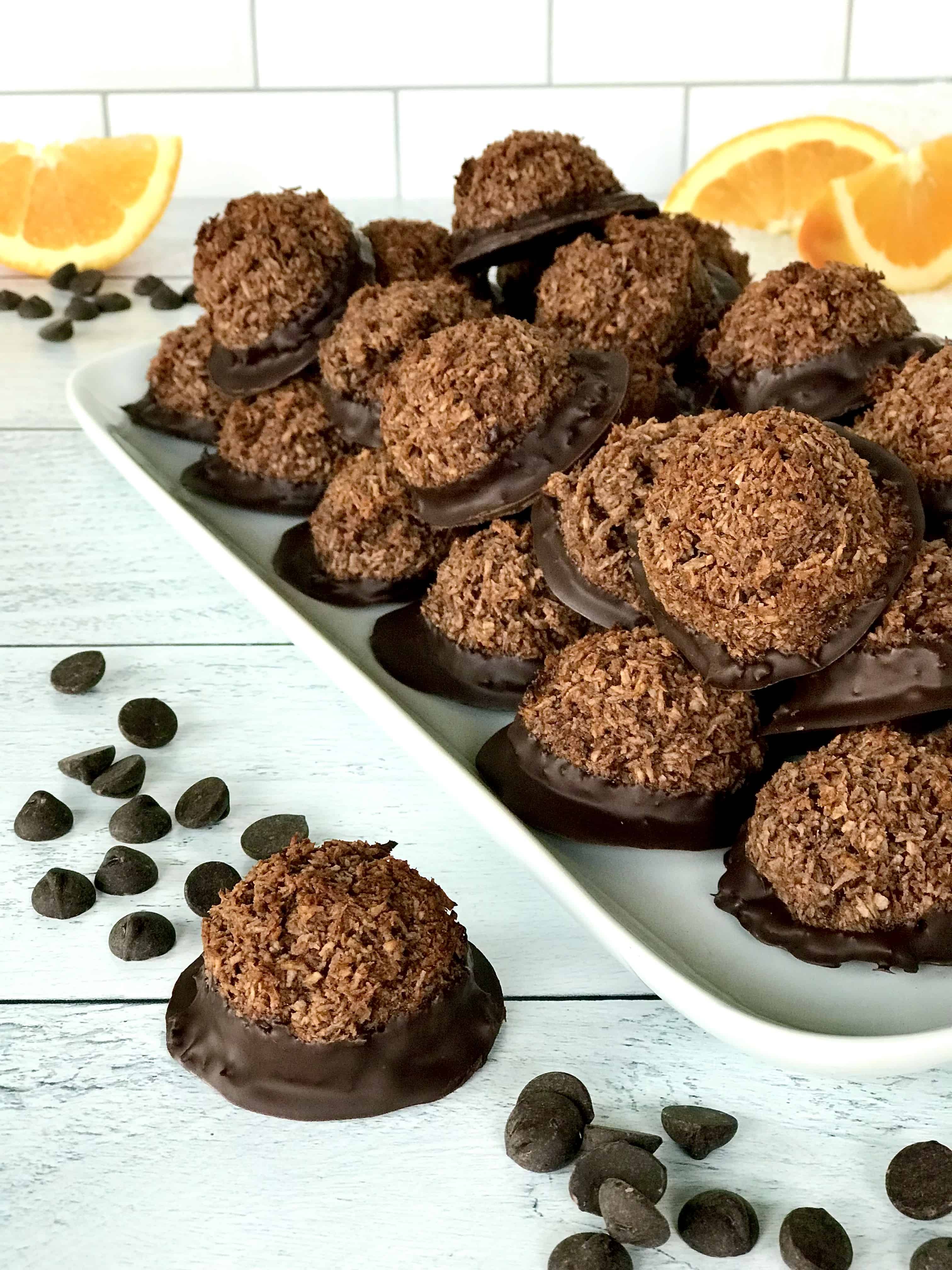 gluten-free macaroons made with cocoa powder and orange zest, piled onto a white platter