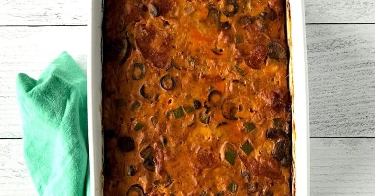A Paleo and Whole30 casserole in a white baking dish next to a green towel