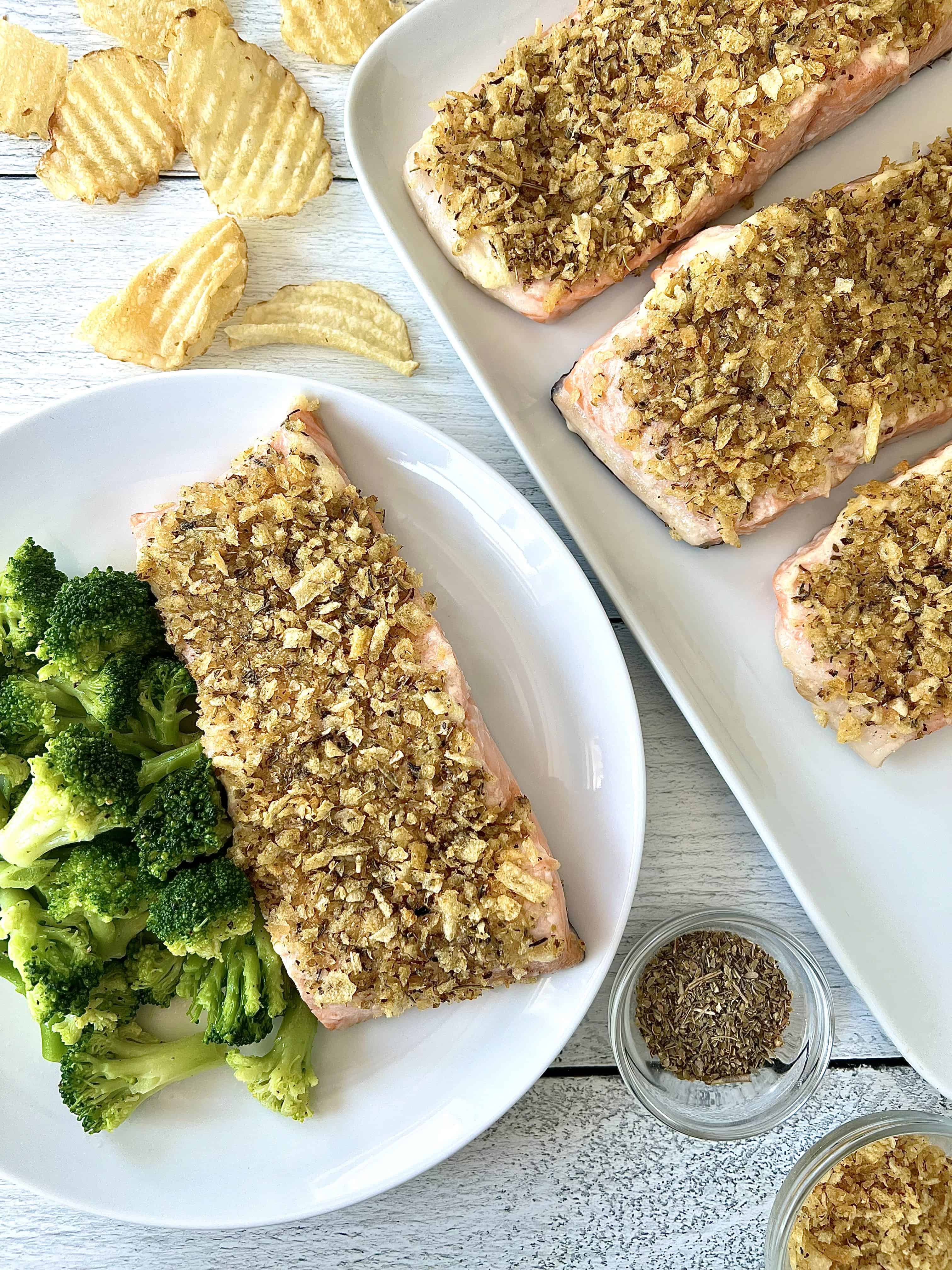 easy baked salmon topped with crushed chips on a white platter and on a white plate with broccoli