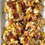 Paleo smashed potatoes on a white platter topped with ranch dressing and chopped bacon
