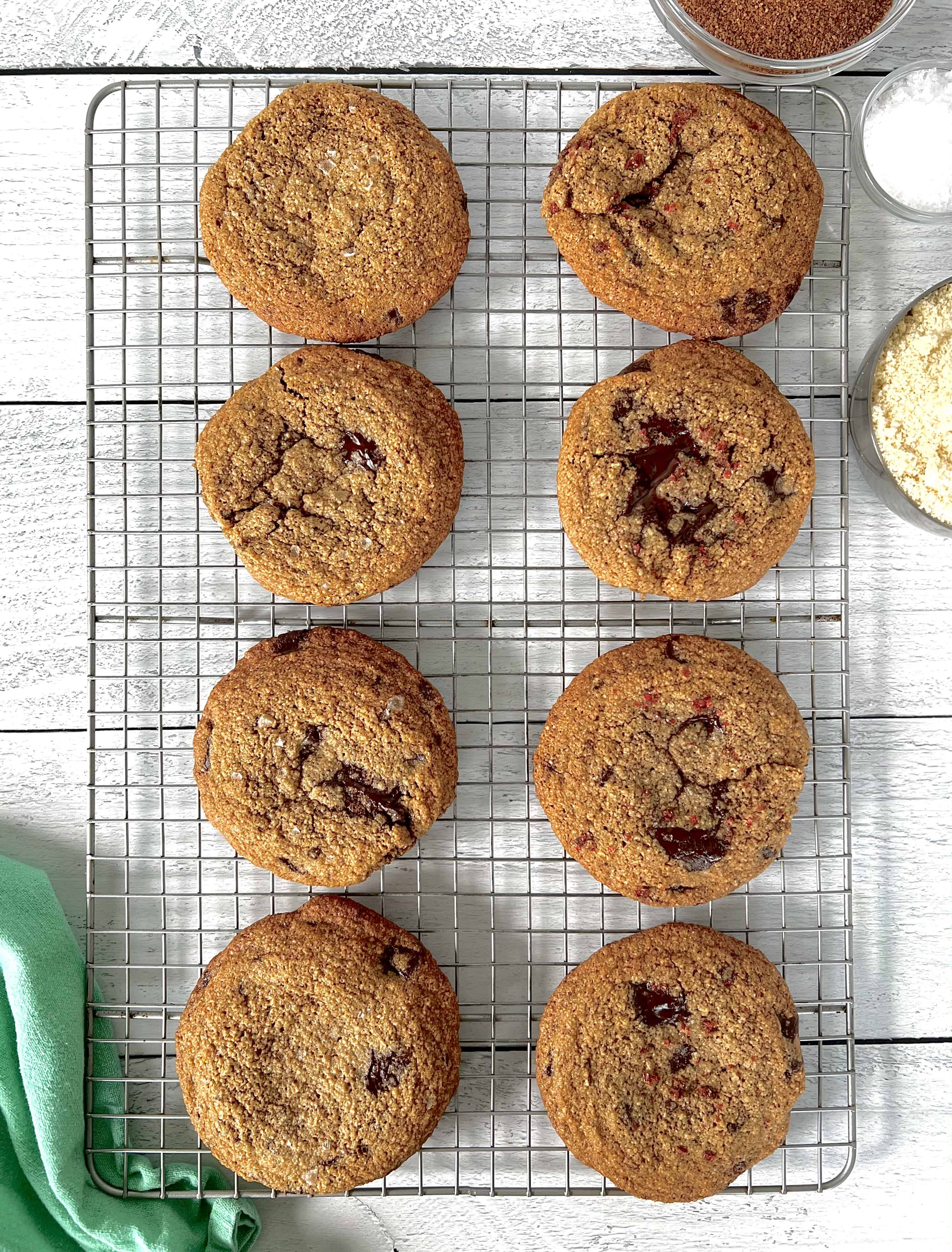 Grain-Free Chocolate Chunk Cookies on a cooling rack on a white wooden table
