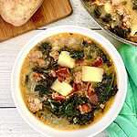 Whole30 Zuppa Toscana in a white bowl next to a green napkin