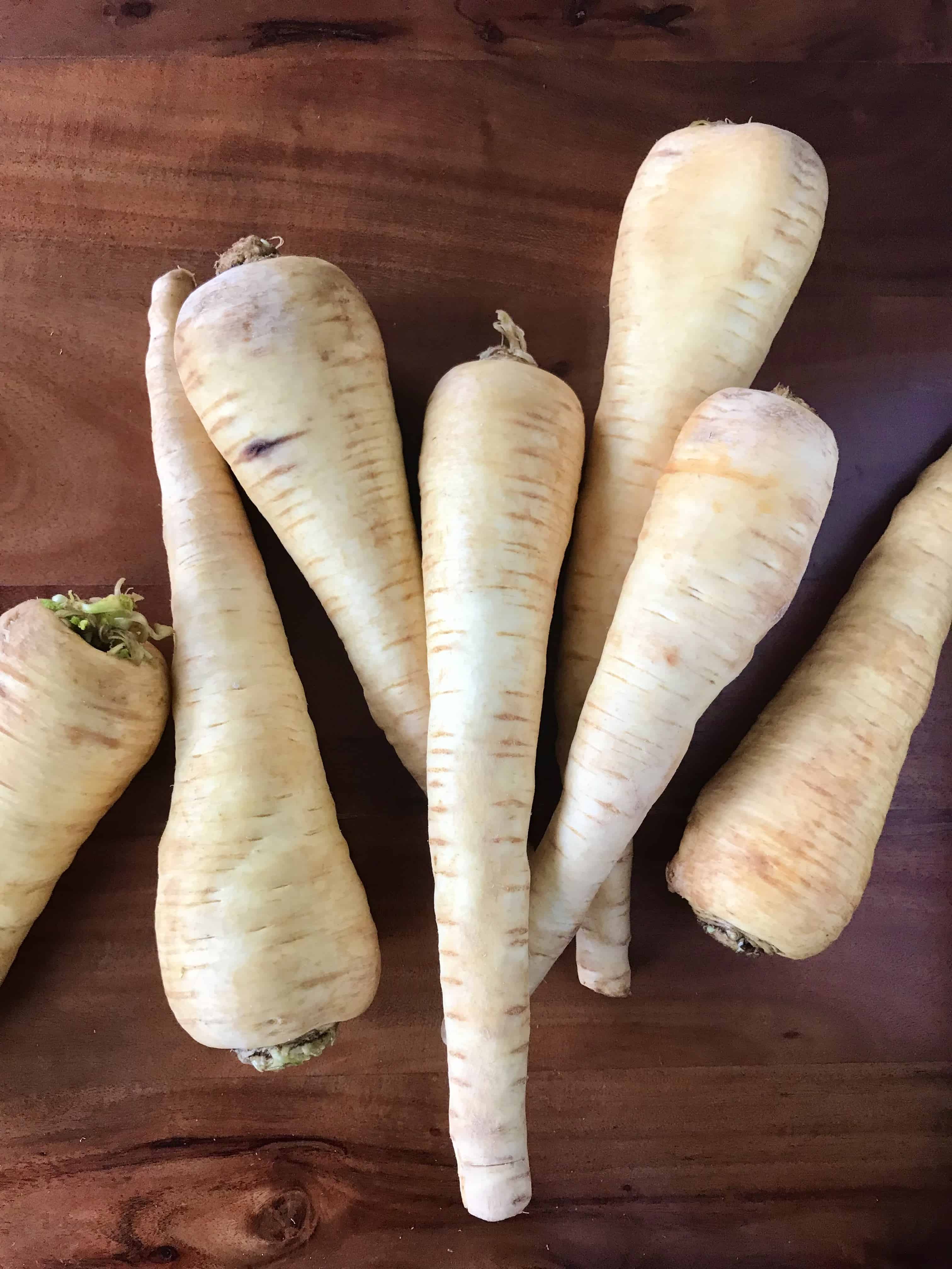 Fresh parsnips on a wooden table.
