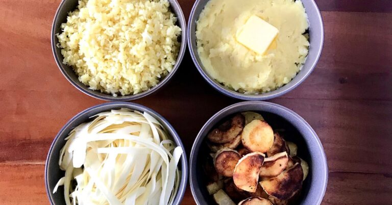 Bowls of roasted parsnips, riced parsnips, mashed parsnips and parsnip noodles on a wooden table.