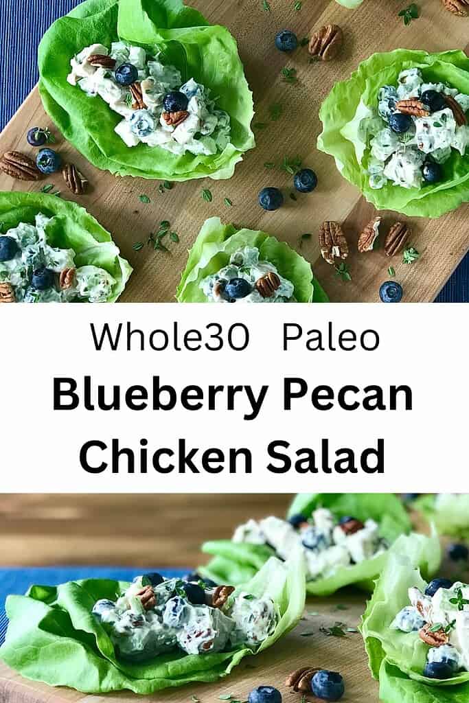 Whole30 Chicken Salad with Blueberries and Pecans on lettuce cups on a wooden cutting board strewn with more blueberries and pecans.