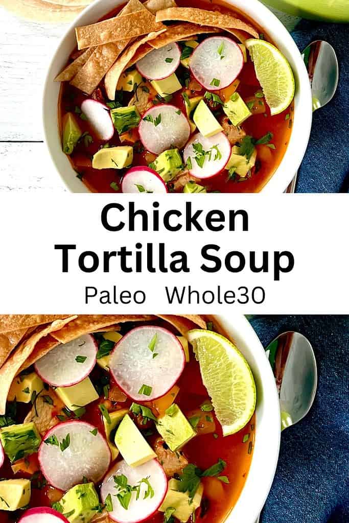 Paleo Chicken Tortilla Soup in a white bowl topped with sliced radishes, cubed avocado, chopped parsley, crispy tortilla strips and a lime wedge.