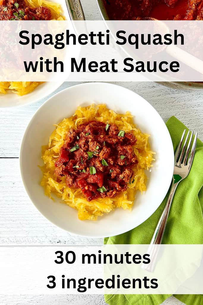 Spaghetti Squash with Meat Sauce in a white bowl next to a green napkin with a fork, another bowl of squash and meat sauce and a pan of sauce.