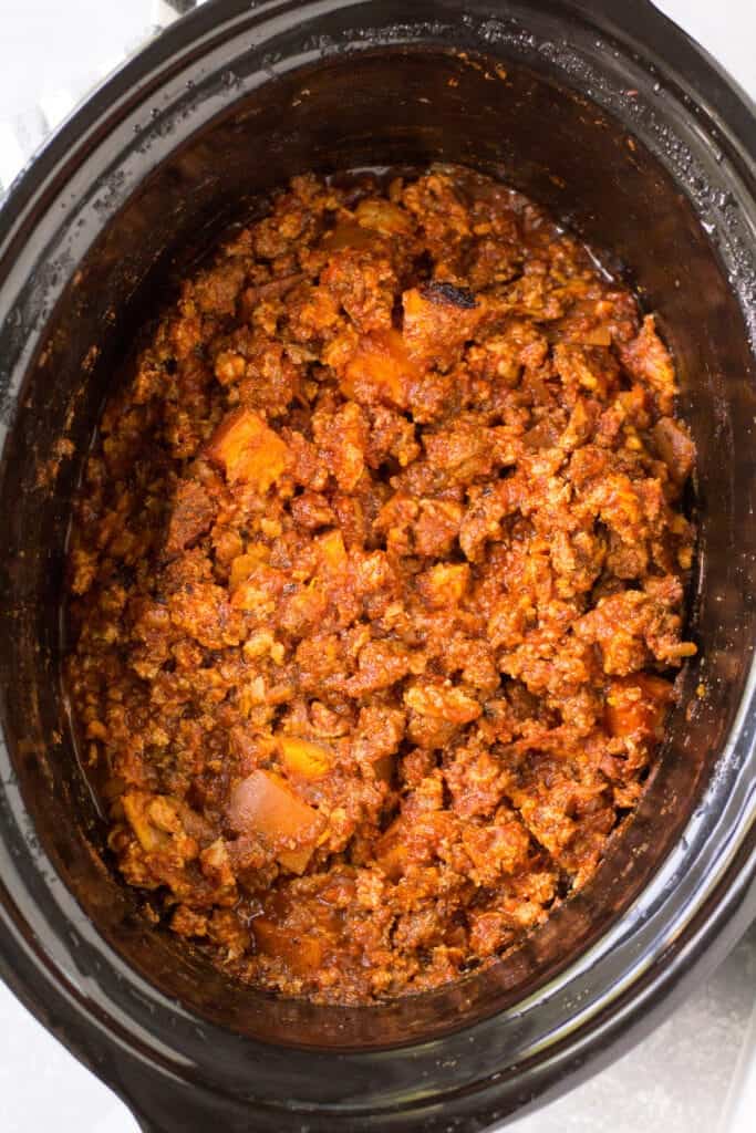 Ground beef and sweet potato chili in a slow cooker insert.
