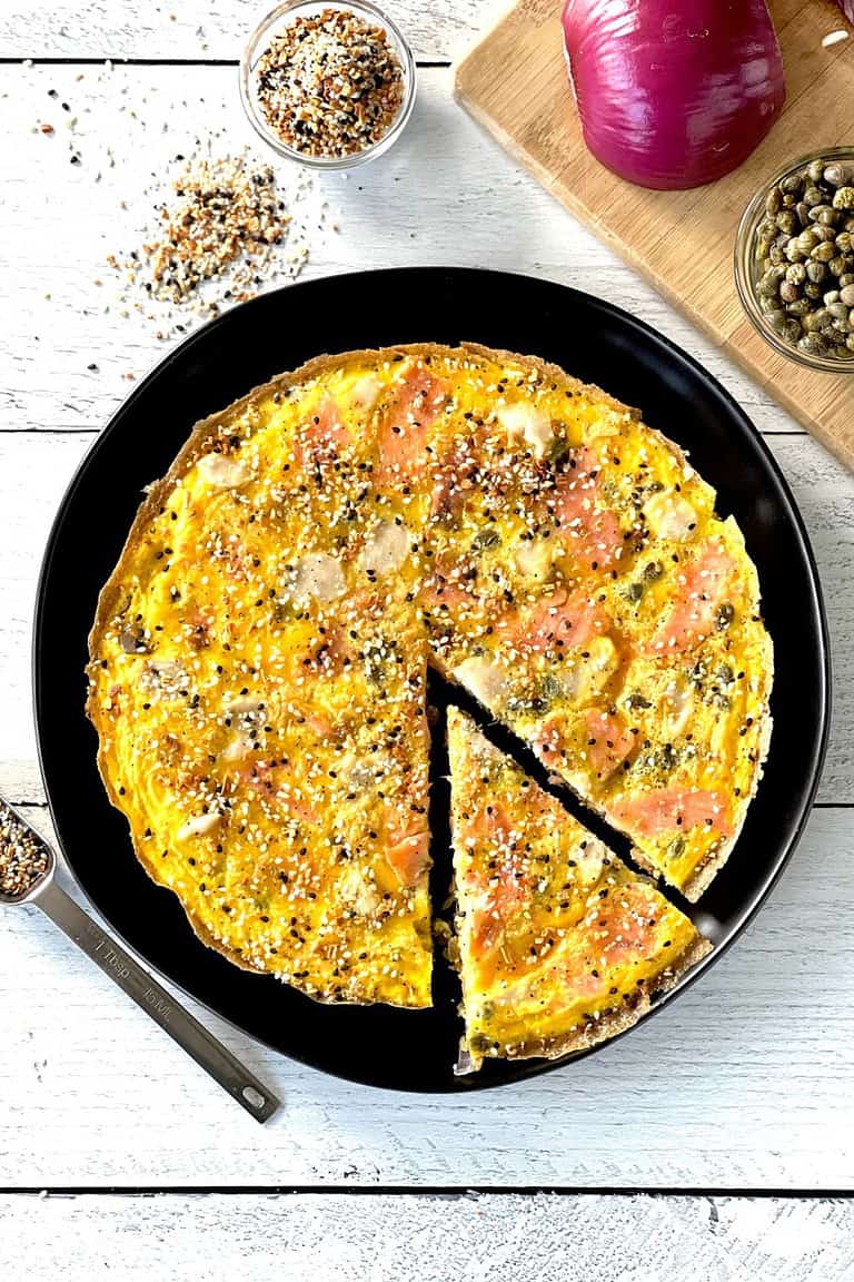 A healthy smoked salmon breakfast bake on a black plate.
