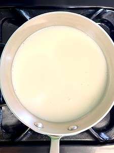 Milk in a saucepan on the stove.