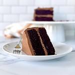 A slice of chocolate cake with almond flour on a plate with a fork.