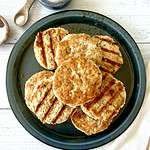 Whole30 chicken patties piled on a plate.
