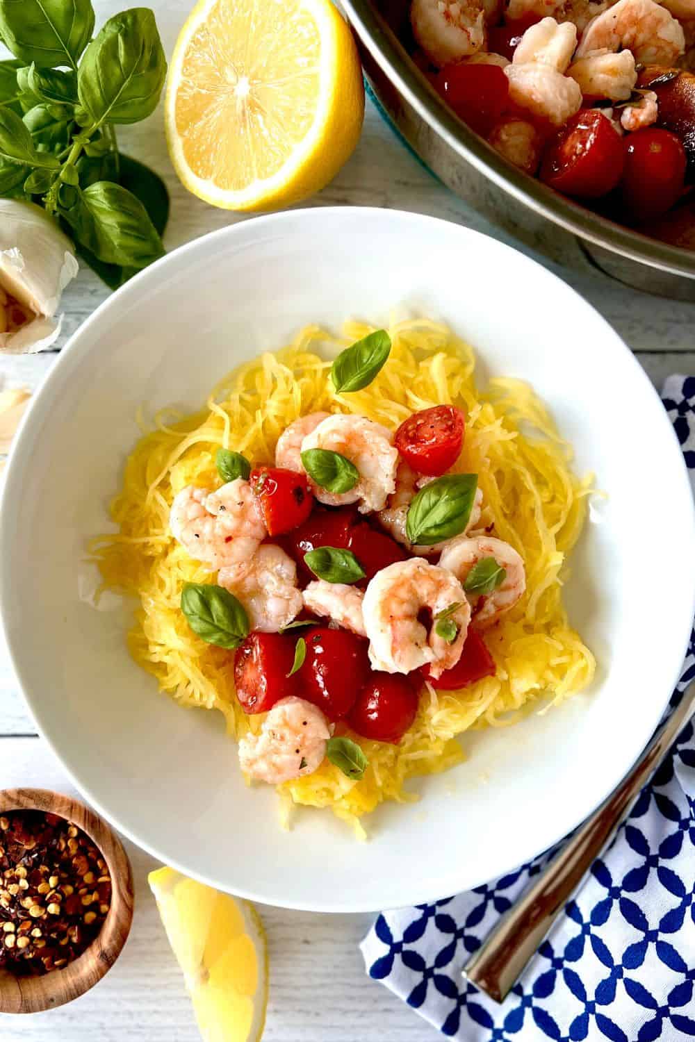 Whole30 shrimp scampi in a bowl next to a napkin with a fork.