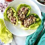 Buffalo-style tuna salad in lettuce cups on a plate.