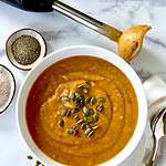 Whole30 butternut squash soup in a bowl topped with pumpkin seeds.
