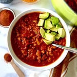 Keto turkey chili in a bowl topped with diced avocado.