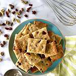 Almond flour cranberry orange shortbread bars piled on a plate.