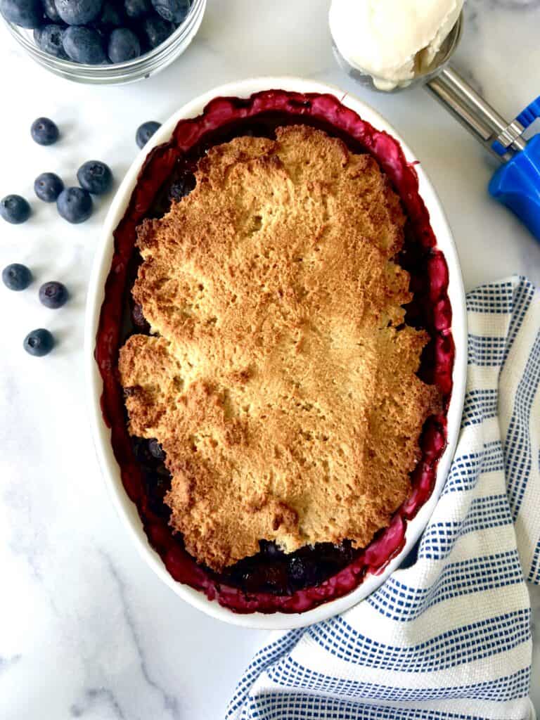 Paleo blueberry cobbler in an oval baking dish.