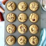 Paleo rhubarb muffins in a muffin pan on a cooling rack.