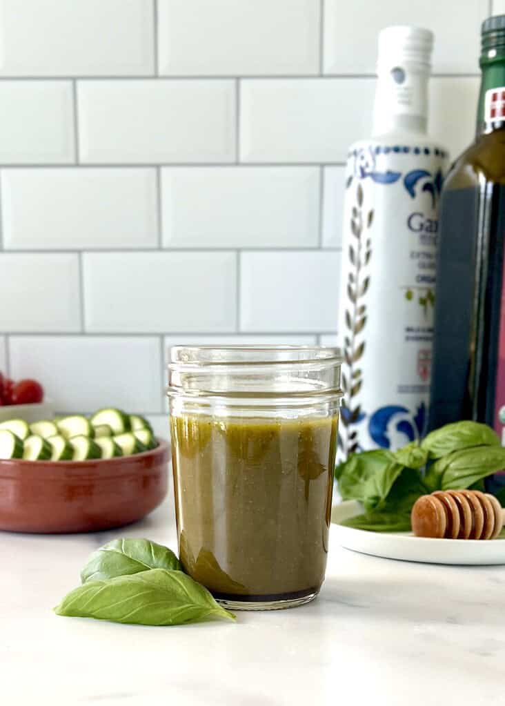 Basil Balsamic Vinaigrette in a glass mason jar.
