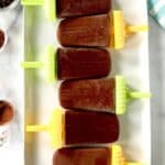 Gluten-free fudgesicles lined up side by side on a rectangular platter.