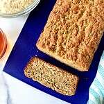 Dairy free zucchini bread on a cutting board with a slice cut away.