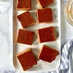 Healthy pumpkin pie bars on a rectangular platter.