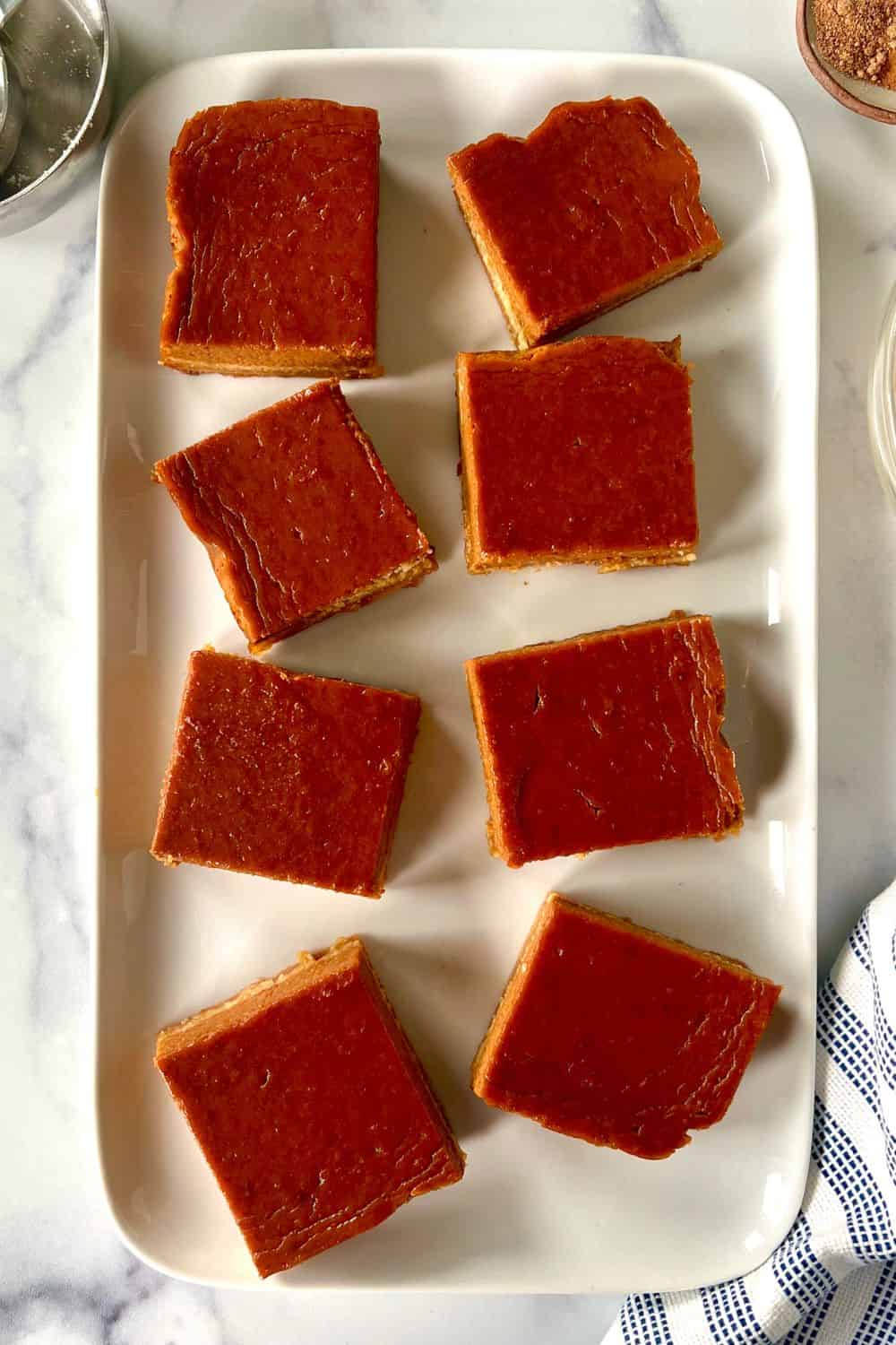 Paleo pumpkin pie bars on a rectangular platter.